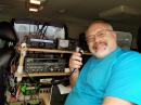 005 - George Mackus - AB0RX at the main operating position behind the drivers seat - showing off the radio equipment